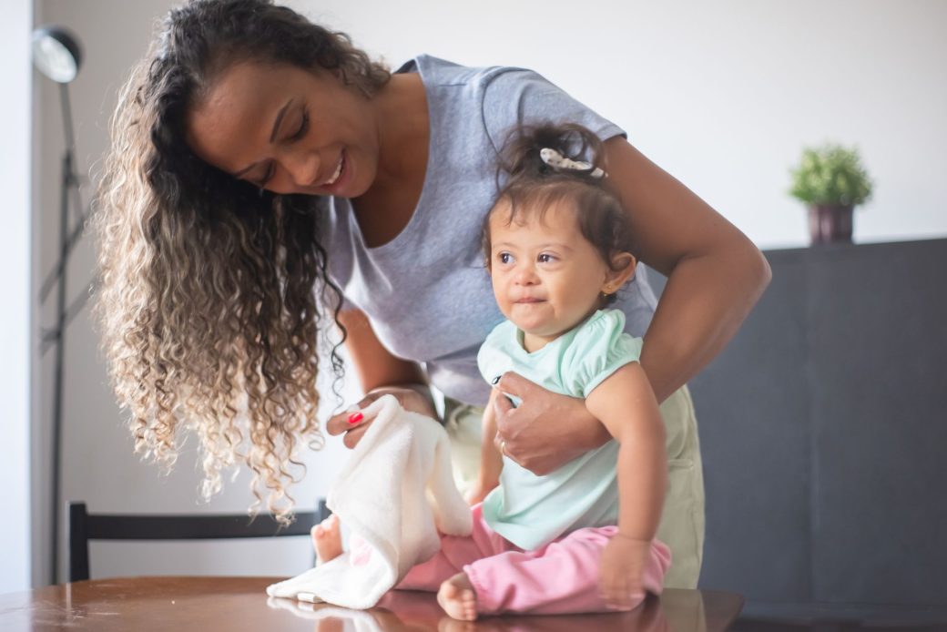 A happy mother and baby bonding in a cozy indoor setting, highlighting family love and care.