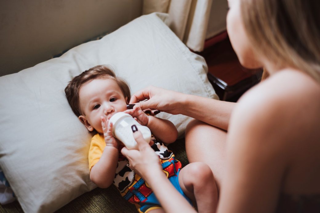 A close-up view of a mother breastfeeding her newborn baby with gentle care and love.