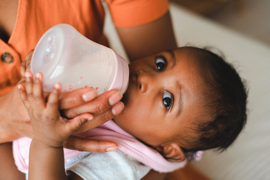 A close-up view of a mother breastfeeding her newborn baby with gentle care and love.
